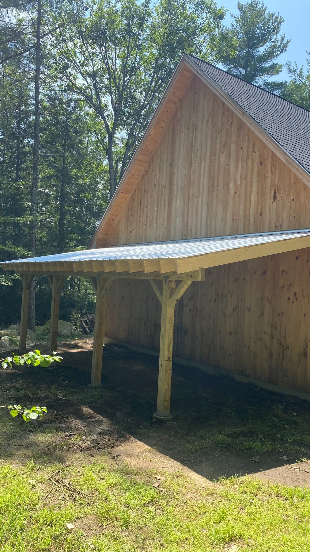 Carport attached to custom outbuilding